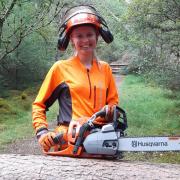 Victoria, pictured with one her trusty Husqvarna saws, is loving life in forestry