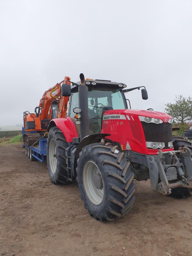 Forestry Journal: A tractor and trailer is used to move equipment.