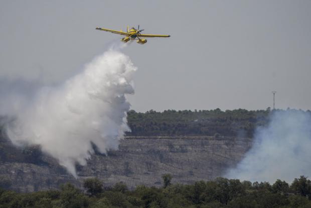 Forestry Journal: An aircraft drops water to extinguish a wildfire in Tabara