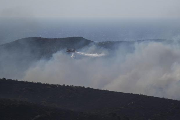 Forestry Journal: A firefighting airplane drops water in the area of Drafi east of Athens on Wednesday, July 20, 2022. Hundreds of people were evacuated from their homes late Tuesday as a wildfire threatened mountainside suburbs northeast of Athens