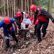 The worker had to be carried up a hillside by mountain rescuers