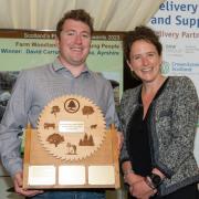 Rural Affairs Secretary Mairi Gougeon presents the Scottish Woodlands Trophy for Young People to David Carruth of Brodoclea.