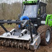 The MM250X is a multi-tool forestry tractor with a three-point linkage on the front, and is hydraulically driven.